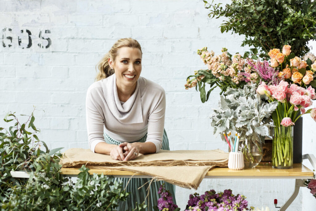 Courtney Ray arranging flowers in the early days of Daily Blooms